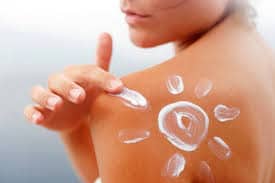 A woman with sunscreen on her shoulder.